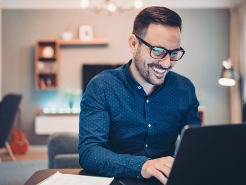 A professional working at his laptop