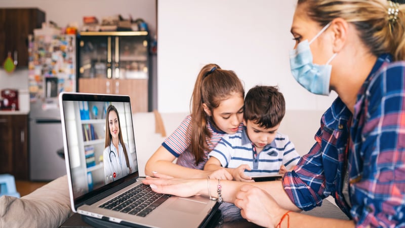 Mother-trying-to-talk-with-doctor-on-laptop-while-watching-two-kids-1216018044_2313x1301 (1)