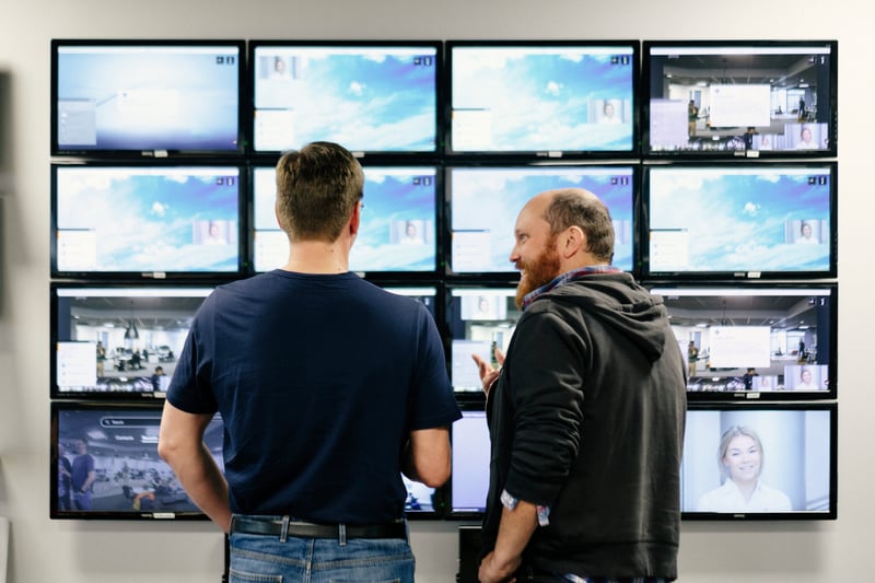 Two people collaborating in front of Pexip testing screens