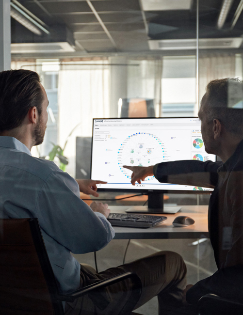two men looking at a dashboard on a monitor